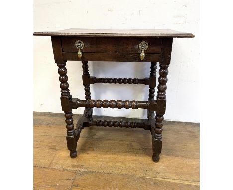 An oak side table, with a single drawer, on bobbin turned legs, 68 cm wide 