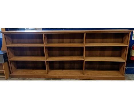 A light oak bookcase, with adjustable shelves, 113 cm high x 270 cm wide 