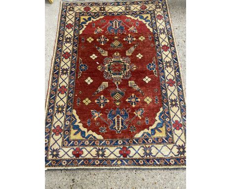 Modern wool floor rug with central red panel, 163 x 130cm