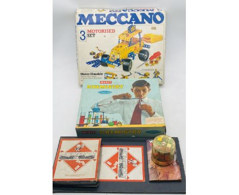 A mixed collection of boxed games and toys including a Meccano Motorised Set, Merit Chemistry set, Monopoly and Rubic's Cube 