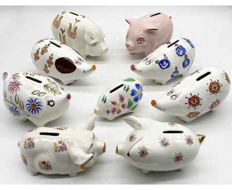 A collection of money boxes in the form of pigs including two by Arthur Wood