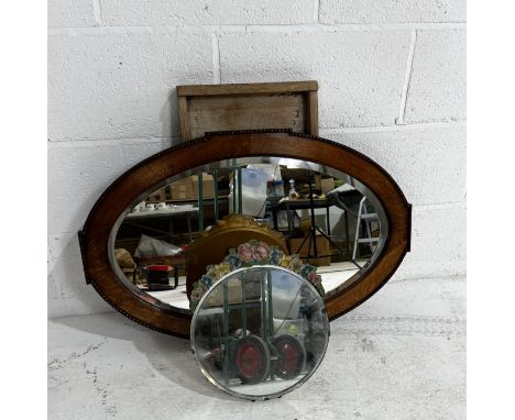 An oak framed mantle mirror along with a dressing table mirror with floral decoration and a washboard