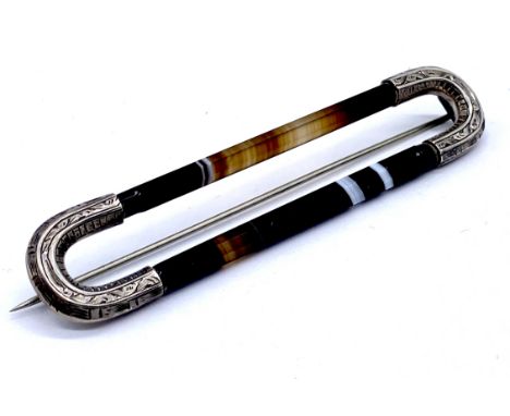 An antique Scottish agate and silver mounted kilt pin 9cm length.