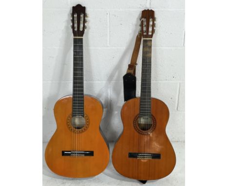 Two acoustic classical guitars, a Royal with a leather strap and a Hohner MC-05