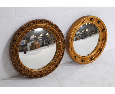 A vintage gilt framed porthole mirror, along with another similar