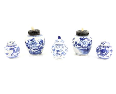 Five blue and white oviform jars, including: two decorated with large flowering peony, overall height including wood cover an