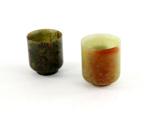 Chinese green and brown mottled jade beaker, on round foot, 6cm high, and another smaller dark green jade beaker, 5.5cm high,