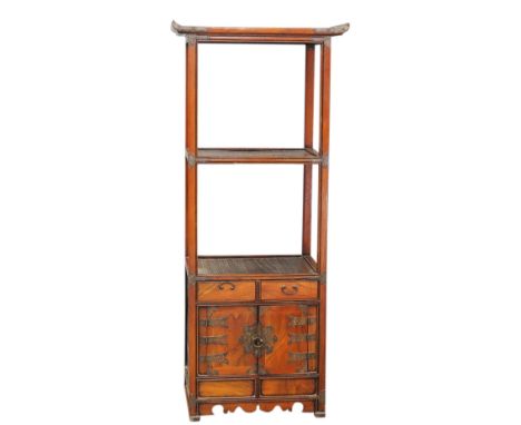 A Korean wood stand, designed with an arrangement of three shelves above a pair of hinged doors and two small drawers, 56 x 3