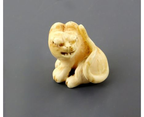 A Kyoto School style ivory netsuke of a seated tiger, unsigned, 19th CenturyPLEASE NOTE: THIS ITEM CONTAINS OR IS MADE FROM I