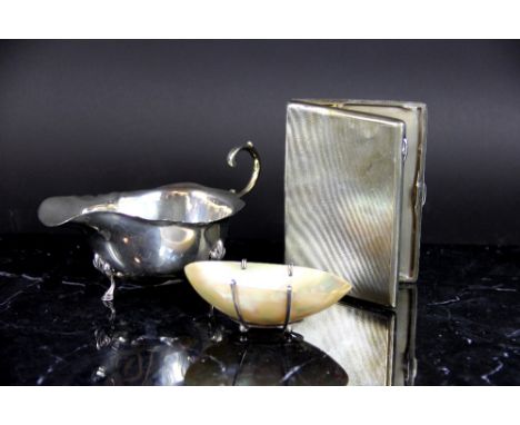 A silver sauce boat Birmingham 1939, weight 93gms, a silver cigarette case Birmingham 1935, of typical engine turned design, 