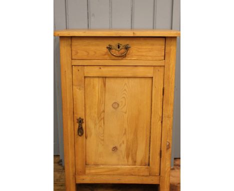 A small pine cupboard, with drawer and cupboard door on bracket feet, 80cm x 55cm x 37cm
