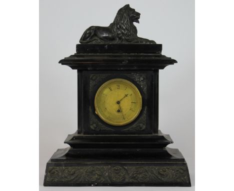 A late 19th century black slate and marble mantel clock, with spelter lion surmount, case decorated with thistles, movement s