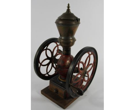 An American cast iron coffee grinder by Enterprise M.F.G Co, with brass hopper and base drawer, gilt decoration, 52cm