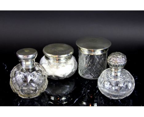 A silver mounted scent bottle and powder jar and cover, Finnigans Ltd London 1924, the clear glass jars with silver tops, eng