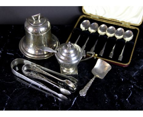 An Edwardian silver bell shaped ink well, marks worn; a pair of George III silver sugar tongs, London, 1801; a pierced pair o