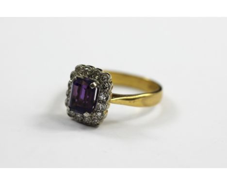 An amethyst and diamond set dress ring, the central rectangular cut amethyst within a surround of sixteen diamonds, all claw 