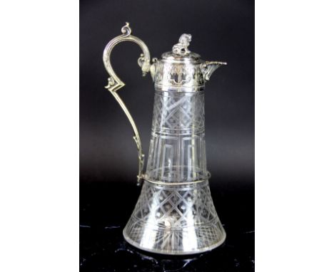 A Victorian claret jug, the clear glass, engraved body with silver plated mounts, lion finial, shell spout and Gothic handle,