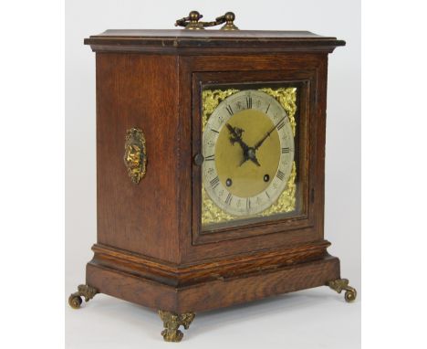 A late Victorian oak bracket clock, with matted brass dial and silvered Roman numeral chapter ring, movement striking on two 
