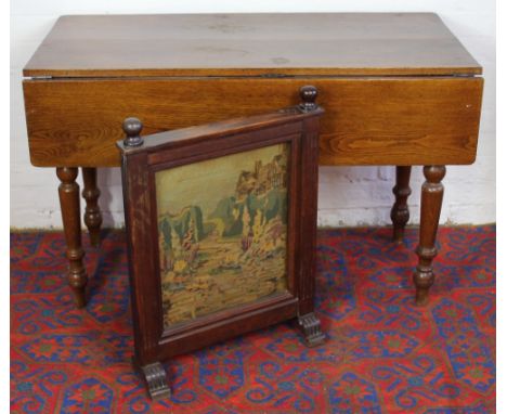 A Victoria oak drop leaf table, on turned legs, 77cm x 152cm x 58cm; and an oak fire screen (2)