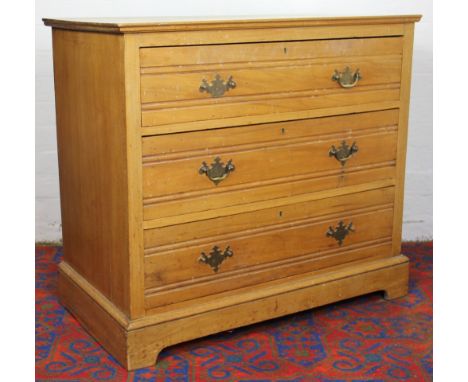 An Edwardian ash chest, of three long drawers on bracket feet, wit label for Cobb & Son 83cm x 92cm x 51cm