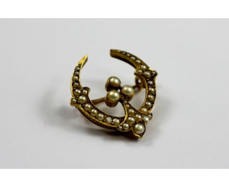 A late 19th/early 20th century split seed pearl set crescent brooch, the graduated pearls all set in yellow gold, unmarked, 2