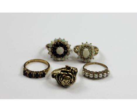 A group of five dress rings, to include a 9ct yellow rose ring, a seven stone pearl ring in 9ct yellow gold, a sapphire and d