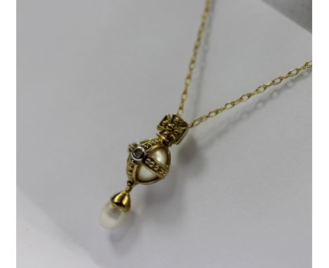 A 9ct gold, pearl and diamond pendant, design as an orb containing an untested pearl and set with a diamond, suspending pearl