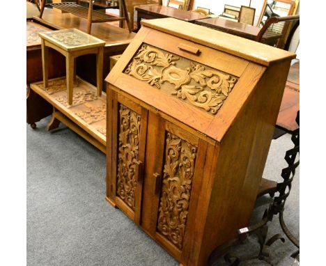 A carved oak bureau, matching side table dated 1944, coffee table and a lamp table (4)