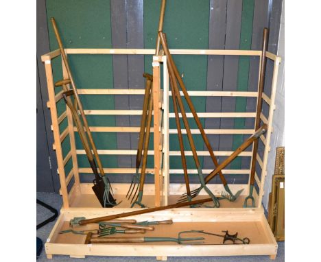 Collection of vintage garden tools in display rack 