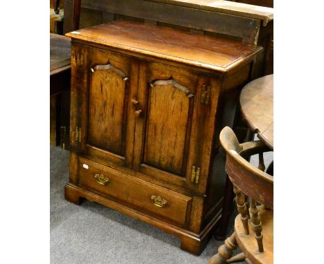 A Titchmarsh & Goodwin oak cabinet, model RL776/NC, two fielded cupboard doors with H brass hinges, a long drawer below with 