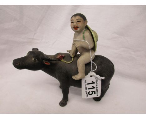 Interesting ceramic boy on buffalo figurine