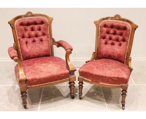 A pair of Victorian ladies and gents walnut and burr walnut armchairs, each with a button back below a break arch rail inlaid