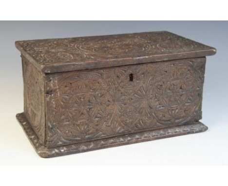 A 17th century chip carved oak box, possibly Welsh, overall carved with geometric and foliate roundels, the hinged top mounte