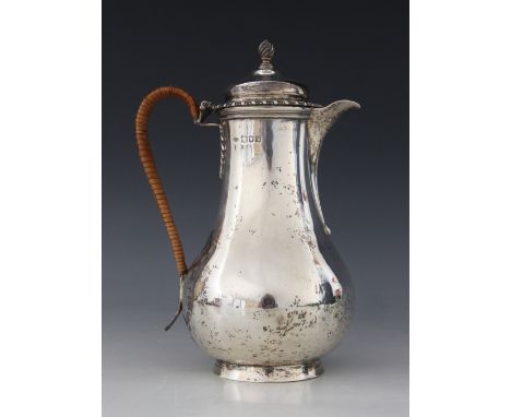 A George V silver hot water jug, John Henry Rawlings, London 1911, of baluster form on raised circular foot, hinged cover wit