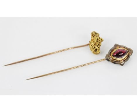 A Victorian 'golden nugget' stick pin, the (untested) nugget measuring 20mm x 12mm, upon a gold coloured pin, 7.7cm long, 5.4