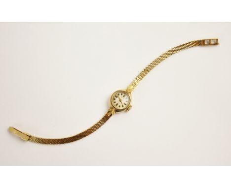 A ladies Kurtz vintage 18ct gold wristwatch, the circular dial with gilt markers, set to a plain polished 18ct gold tonneau d
