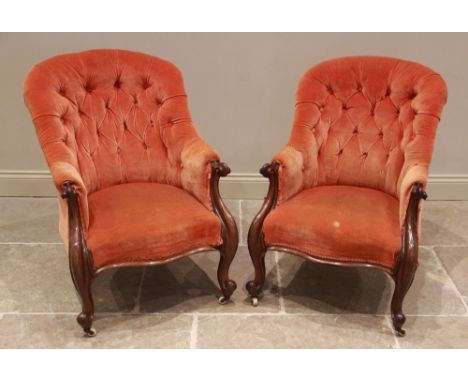 A pair of Victorian rosewood tub type armchairs, later re covered, the button backs extending to carved scroll terminals encl