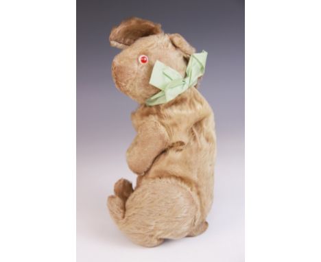 An articulated Steiff style toy rabbit, early 20th century, the wood wool filled rabbit with heavily worn golden mohair, pink