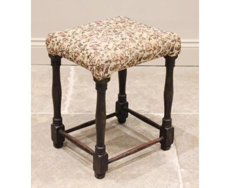 A 19th century and later oak dressing stool, the later upholstered rectangular top raised upon ring turned swelling supports,