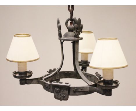 A 17th century style iron strapwork chandelier, 20th century, the three fleur-de-lis finials above strapwork branches united 
