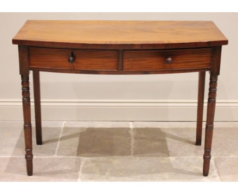 A 19th century mahogany bow front console table, with two equal short drawers, one lockable with key, raised on bobbin turn f