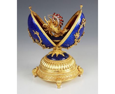 A Limited Edition musical 'Faberge Firebird Egg' by Franklin Mint, the silver gilt egg with blue guilloche enamel decoration,