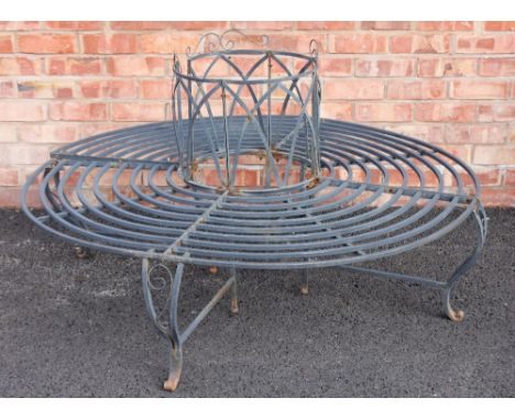 A painted metal box section tree bench, late 20th century, formed from radiating rings upon curved supports, 142cm diameter, 