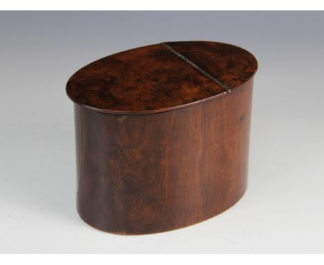 A George III walnut tea caddy, of plain polished oval form with hinged cover, silvered paper lining, 16.5cm x 10.5cm x 12cm 