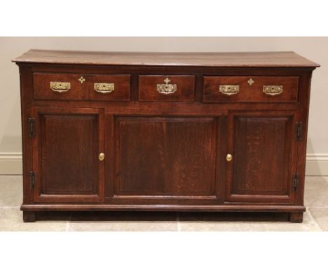 A George II oak dresser base, the rectangular moulded plank top above an arrangement of three lip-moulded frieze drawers, app