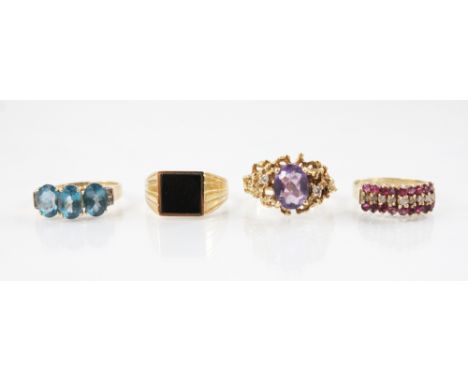 An amethyst and diamond 14ct gold ring, the central oval mixed cut amethyst measuring 9mm x 7mm, flanked by two small round b