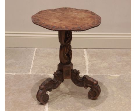 An Italian carved hardwood tripod table, late 19th century, the circular top with a leaf carved wavy rim, upon a 'C' scroll f