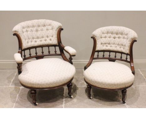 A pair of Victorian walnut tub chairs, each with a padded button back above a spindled gallery and a bow front sprung seat, r