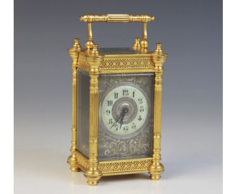 A late 19th century French brass cased carriage timepiece, the case with filigree detail and fluted columns enclosing the 5cm
