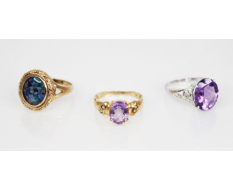 An amethyst and diamond 10ct gold ring, the central oval mixed cut amethyst measuring 12mm x 10mm, diamond chips set to pierc